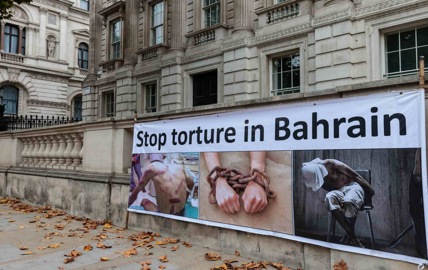 A banner reading “Stop torture in Bahrain” is positioned against a wall close to Downing Street during a small protest in Whitehall by Bahrain Freedom Movement activists.