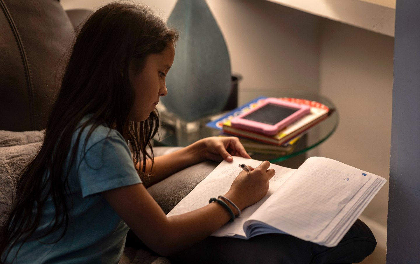 Undocumented third grader Yanela Sanchez practices math at her family's apartment