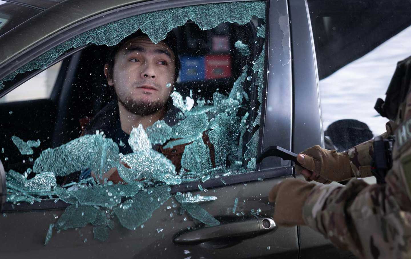 US Border Patrol agents smash a man's car window before dragging him out and taking him into custody when he failed to present citizenship documentation at a gas station on January 11, 2026, in St. Paul, Minnesota. The Trump administration has sent an estimated 2,000 federal agents into the area as they make a push to arrest undocumented immigrants.