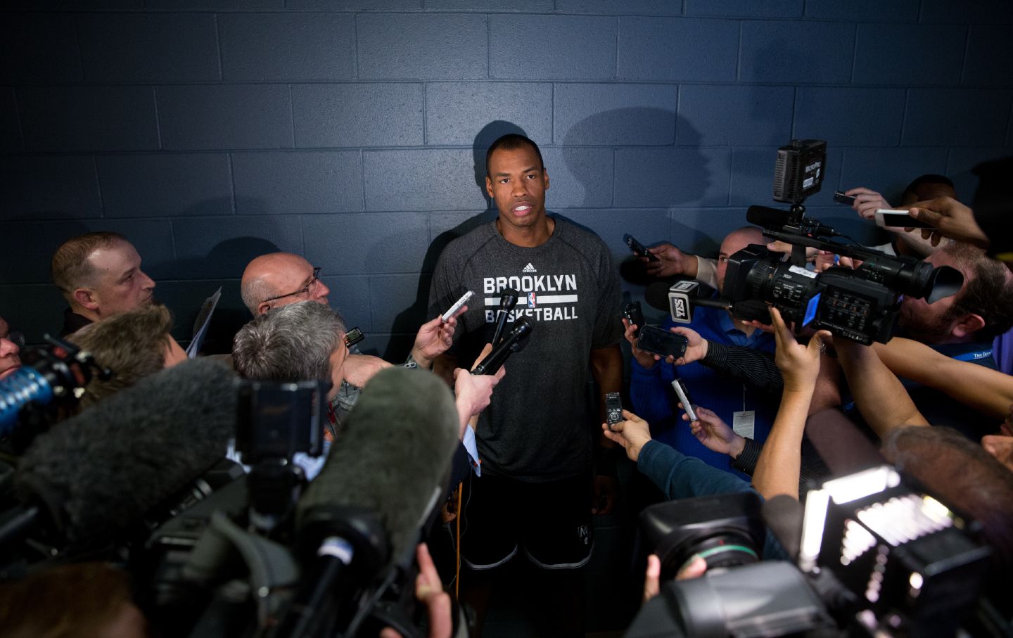 Jason Collins, #98 of the Brooklyn Nets, speaks with the media prior to a game against the Denver Nuggets on February 27, 2014, in Denver, Colorado.