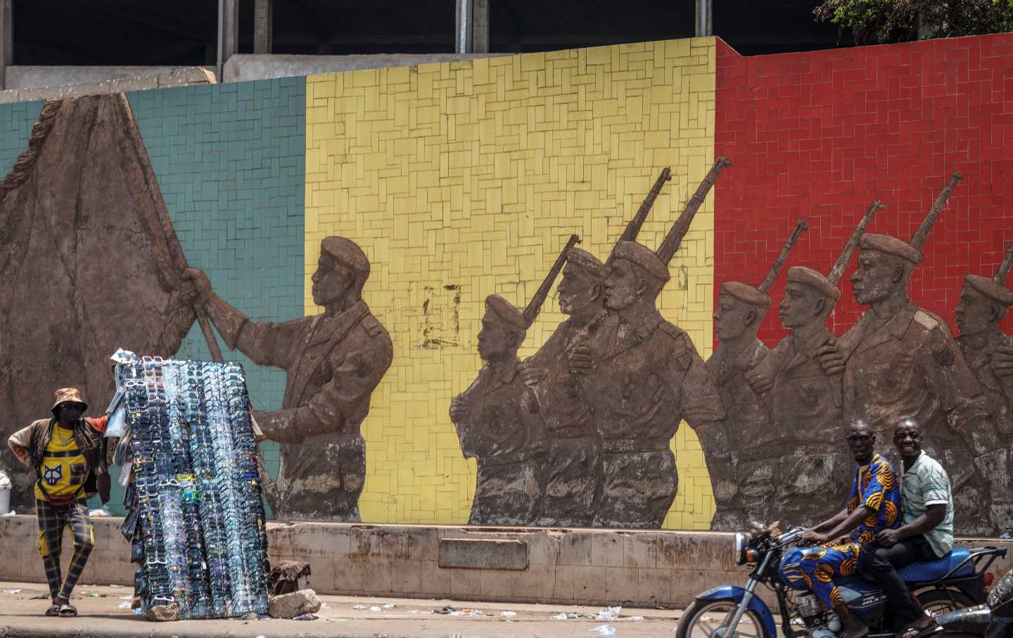 A motorcyclist rides past a monument in Bamako in support of the Malian Army after surprise attacks by Tuareg rebels of the Azawad Liberation Front (FLA) coalition and the jihadist Group for the Support of Islam and Muslims (JNIM) targeted several areas in the vast arid country, on April 26, 2026.