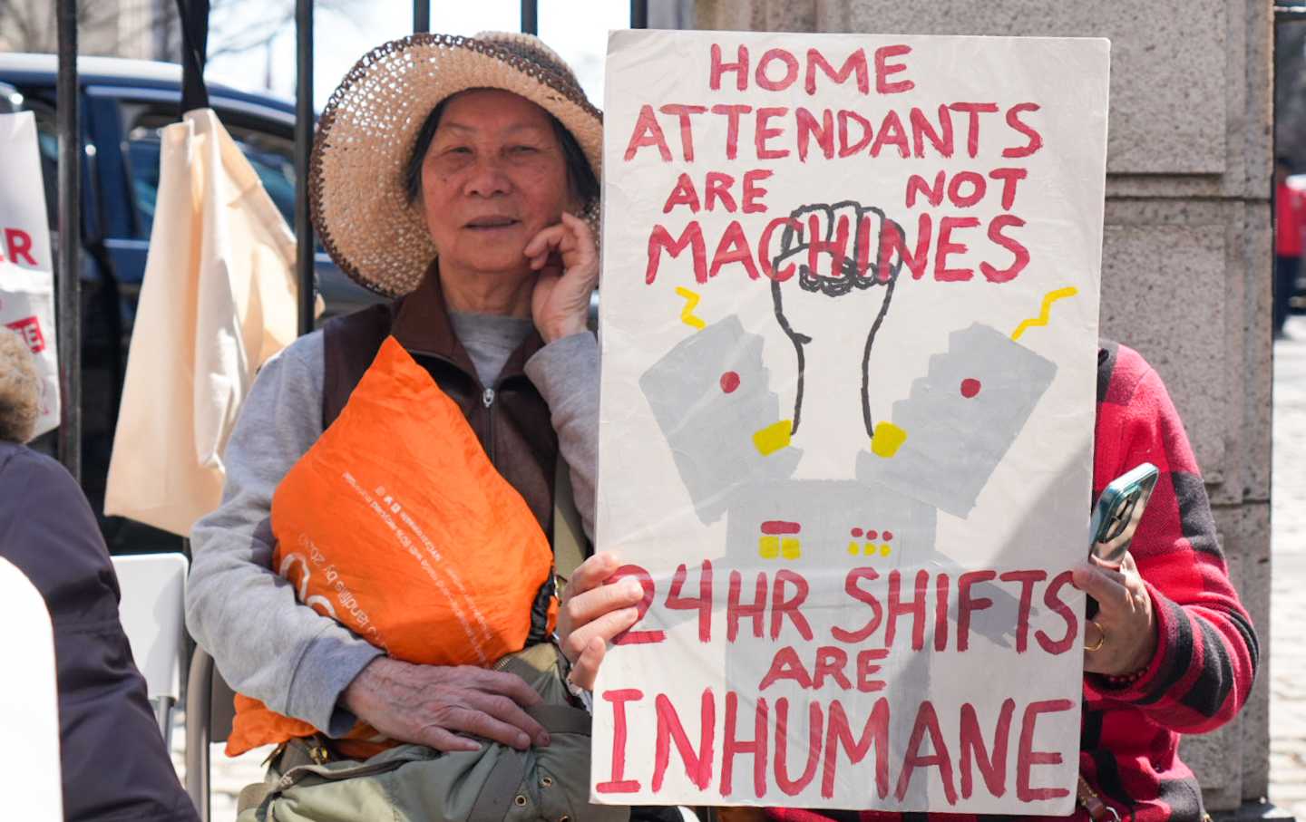 Home care workers hold a sit-in outside City Hall.