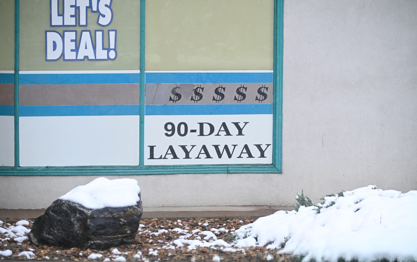 Snow accumulates outside a pawn shop in Longmont, Colorado, on May 6, 2026.