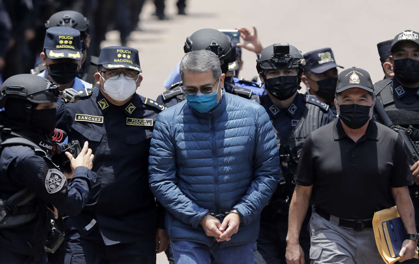 Former president of Honduras Juan Orlando Hernandez is escorted by Members of the Police Special Forces to be extradited to US to face charges of taking bribes from drug traffickers.