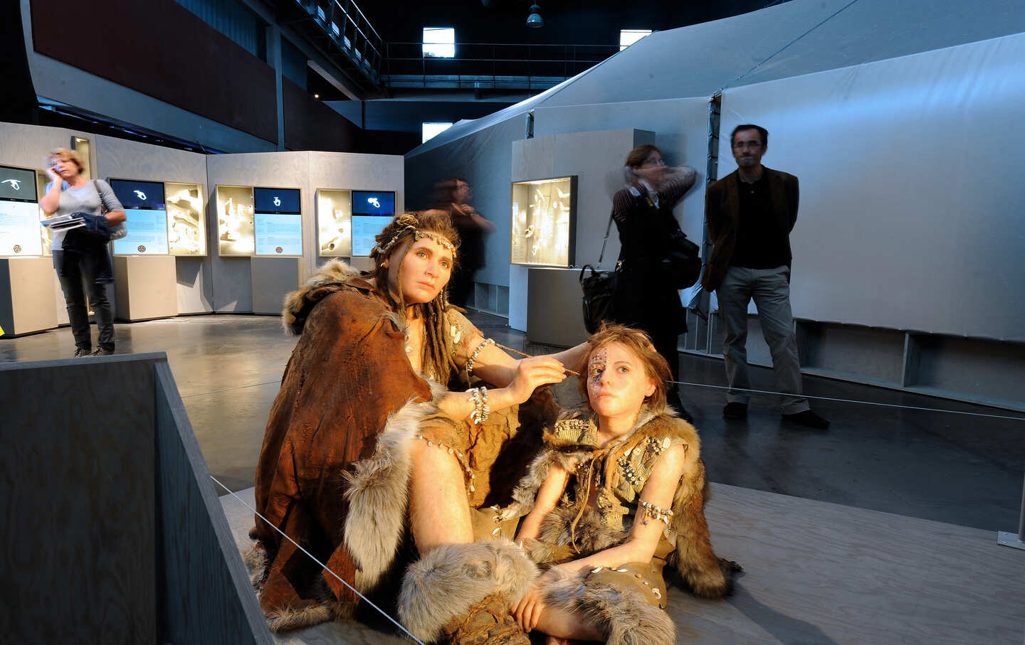 Visitors pass by wax figures representing Cro-Magnon humans, the early Homo sapiens sapiens such as those who painted in the Lascaux caves.