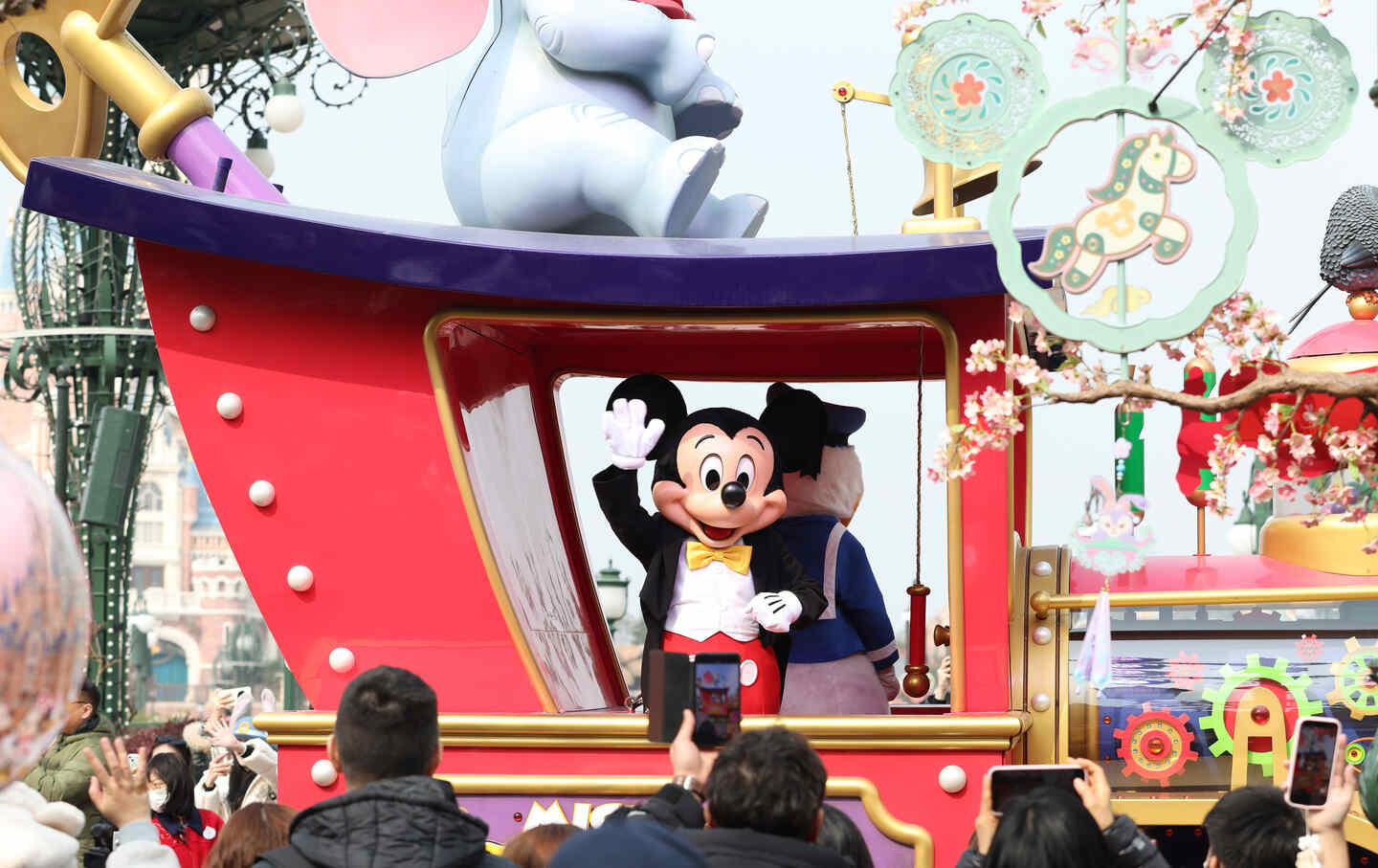 Mickey Mouse in festive costume interacts with visitors at Shanghai Disney Resort in Shanghai, China.