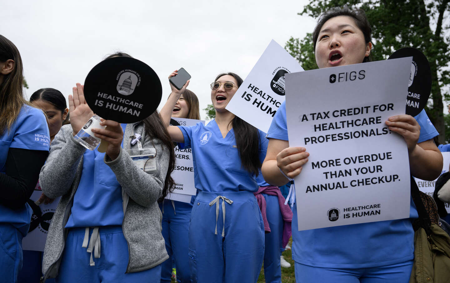 Nurses and healthcare workers cheer during the healthcare apparel company FIGS’s“ Healthcare Is Human” rally on Capitol Hill in Washington, DC.