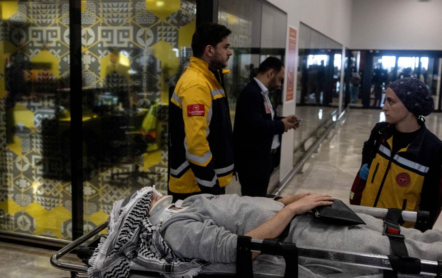 : Injured activists from the Gaza-bound Global Sumud Flotilla, detained by Israeli forces after their vessels were intercepted in international waters in the Mediterranean, gather upon arrival at Istanbul Airport on May 21, 2026 in Istanbul, Turkey.