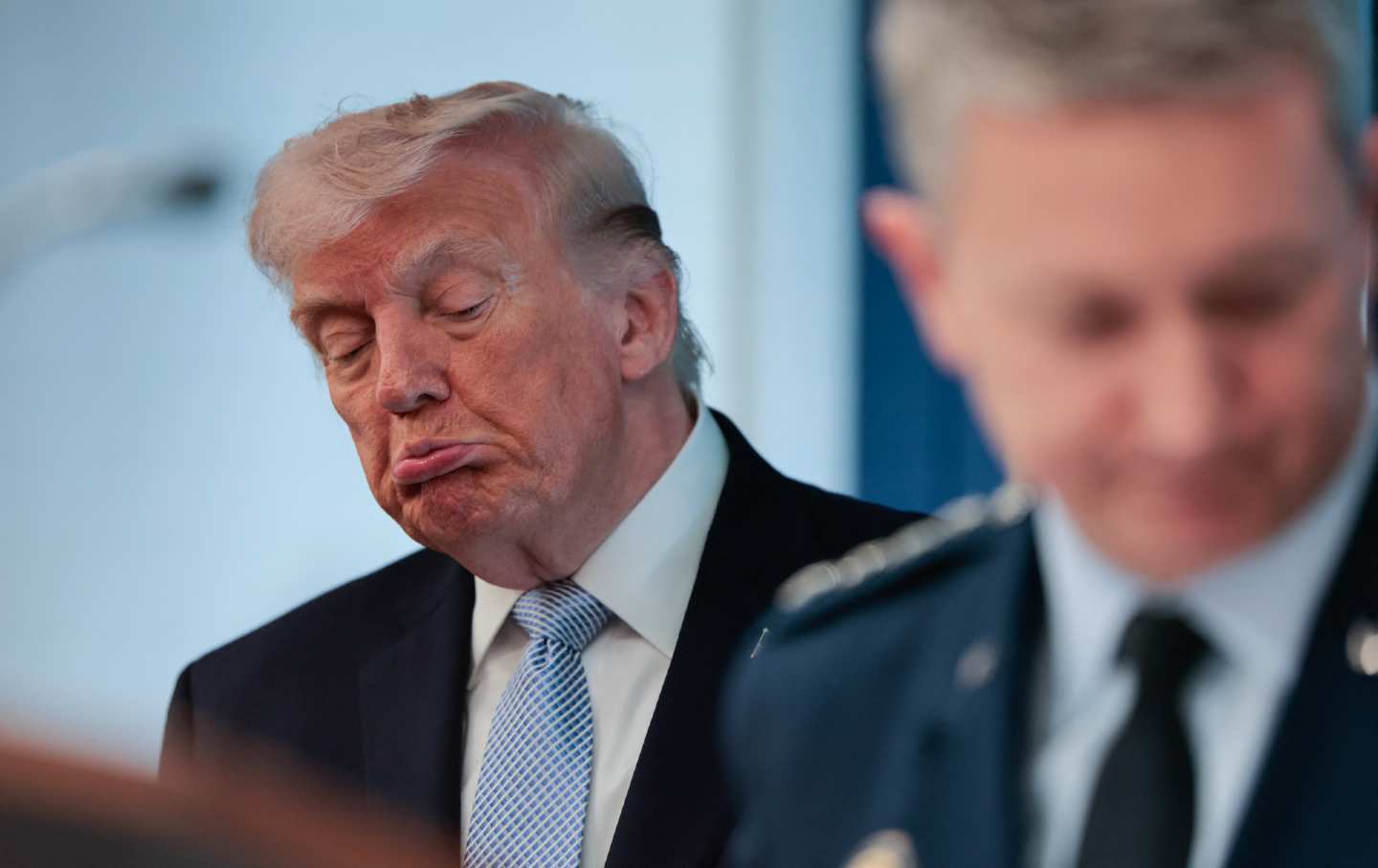 President Donald Trump stands alongside Chairman of the Joint Chiefs of Staff Dan Caine at an April press conference on the Iran war.