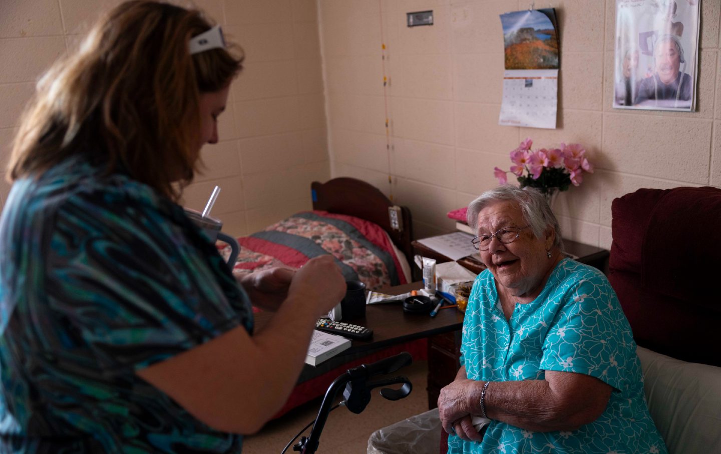 A certified nursing assistant helps a women in her care in Wisconsin, on November 15, 2024.