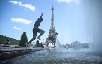 People jump in the Trocadero Fountain near the Eiffel Tower during a heat wave in Paris on June 22, 2026.