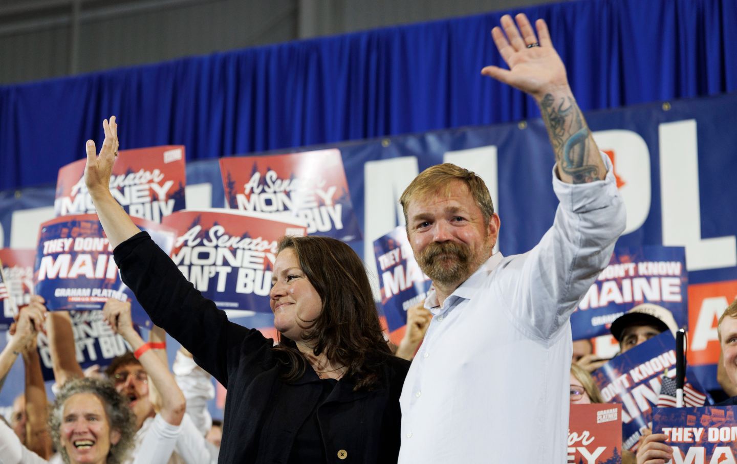 Democratic US Senate candidate Graham Platner and his wife, Amy Gertner, wave to supporters as they arrive at Platner’s primary election event in Blue Hill, Maine, on June 9, 2026.
