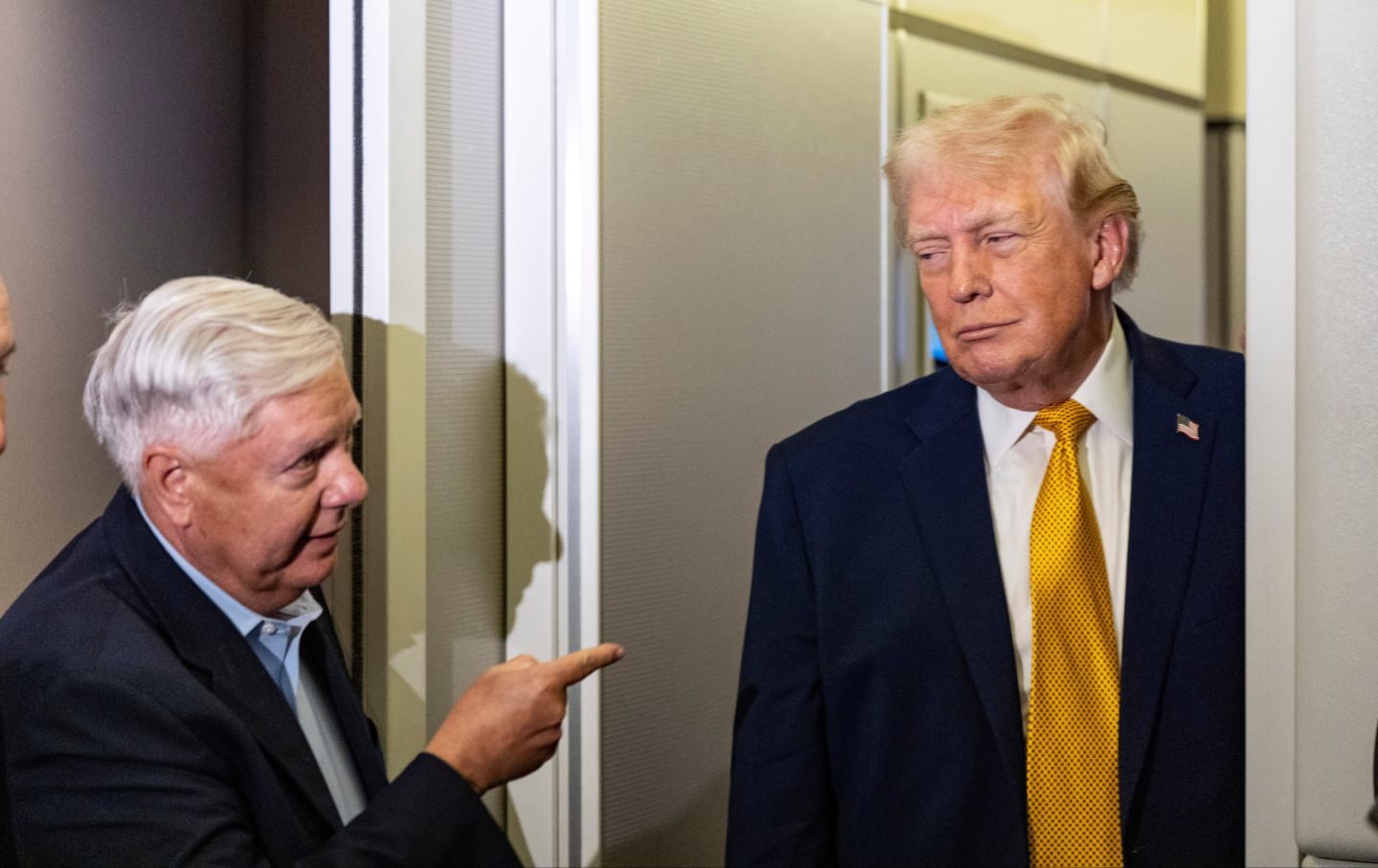 Sen. Lindsey Graham, R-S.C., left, gestures as President Donald Trump speaks with reporters while in flight on Air Force One, Jan. 4, 2026, as they were returning to Joint Base Andrews, Md.