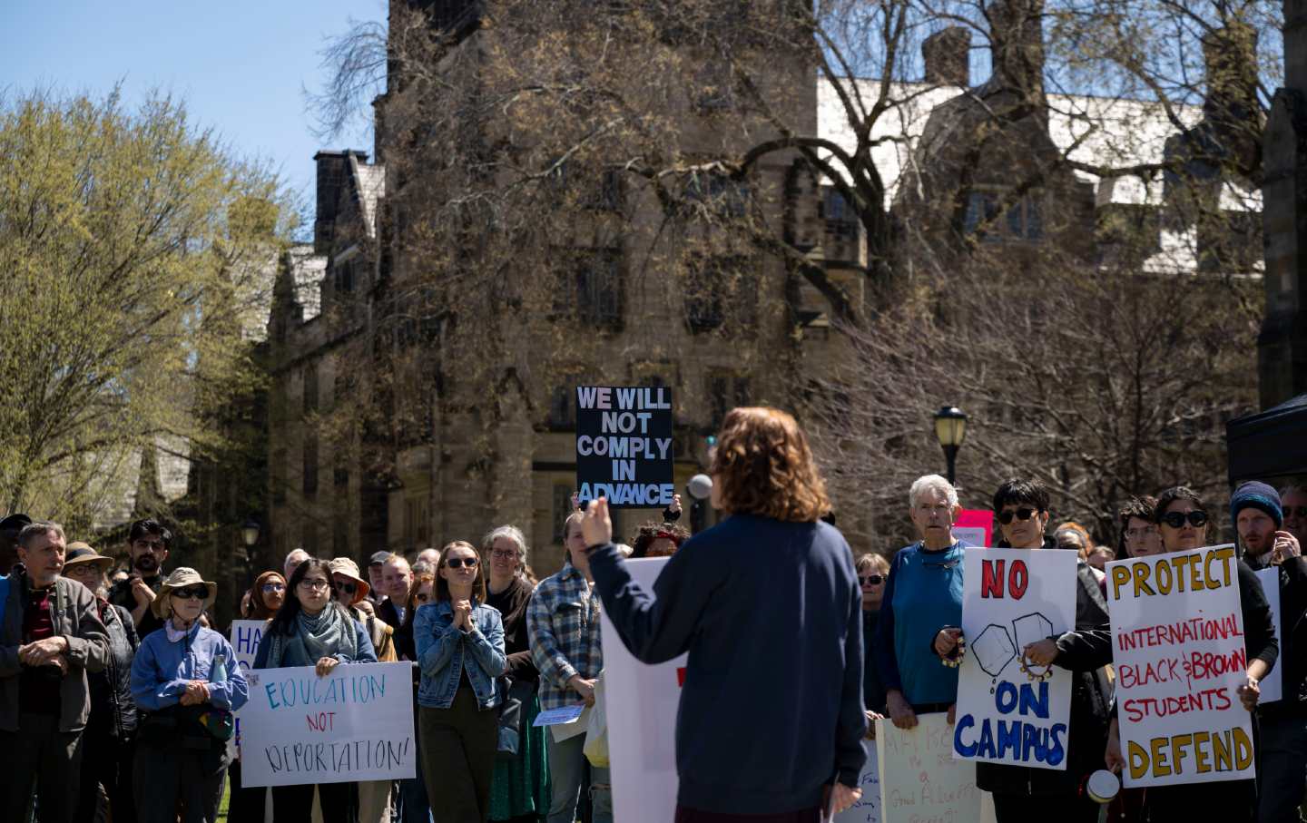 Yale University faculty members rally on campus to call on administrators to protect academic freedom at the university against pressures from the federal government.