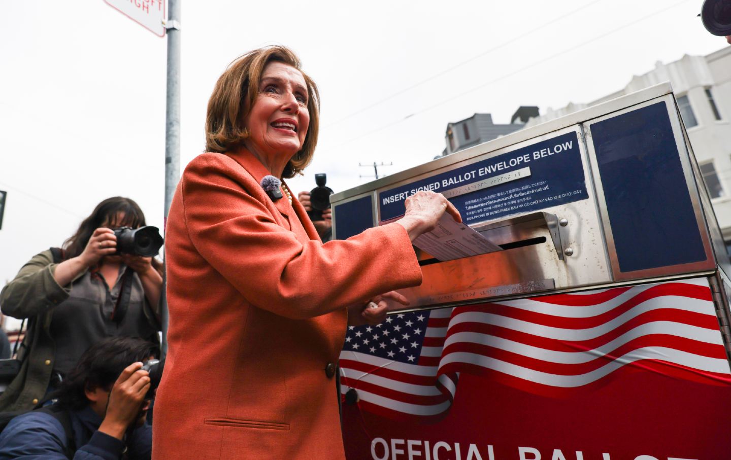 Nancy Pelosi, puts her ballot envelope in a ballot box during the 