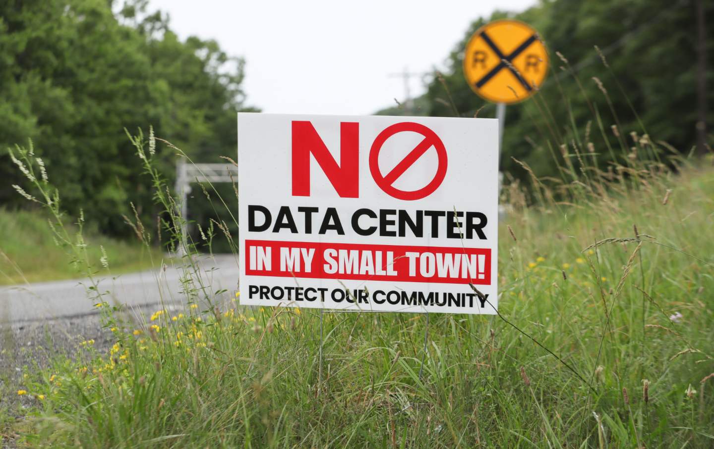A yard sign opposing a planned data center is displayed along Route 54 in Mount Carmel Township.