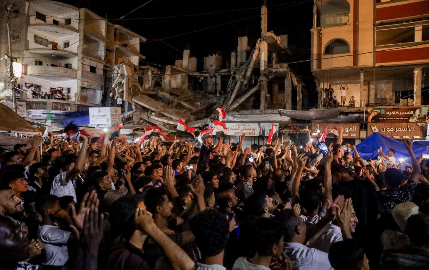 Palestinians wave Egyptian flags as they gather to watch Egypt's World Cup match in Gaza City, on July 4, 2026.