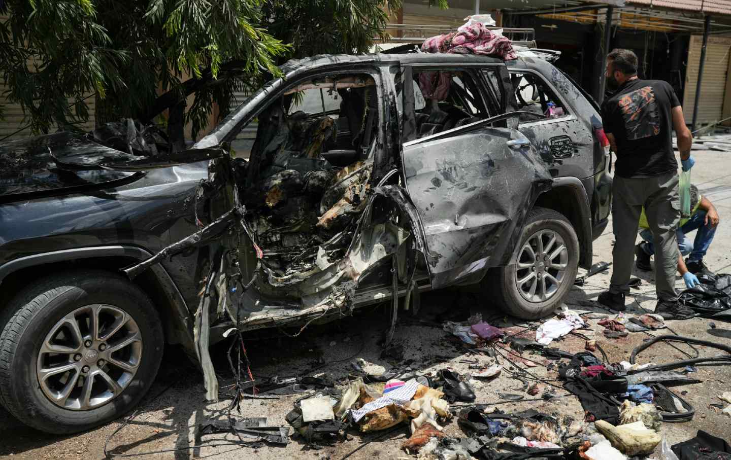 First responders inspect the wreckage of a car reportedly targeted by an Israeli strike in Nabatieh, in the south of Lebanon, on July 6, 2026, which Lebanese state media said killed four people, including three women.