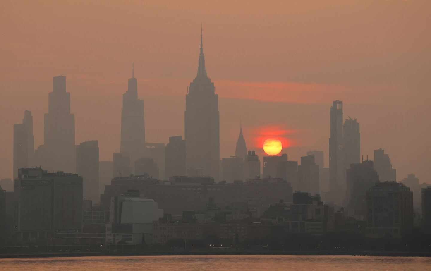 Wildfire smoke from Canada shrouds the sun behind the skyline of New York City on July 17, 2026.