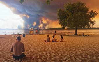 Beachgoers rest on the beach of Moutchic on the shore of Lake Lacanau.
