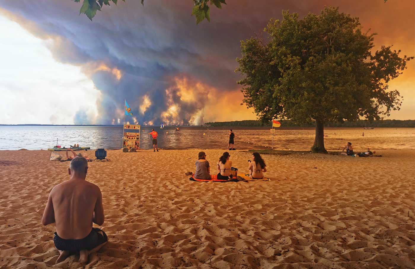 Beachgoers rest on the beach of Moutchic on the shore of Lake Lacanau.