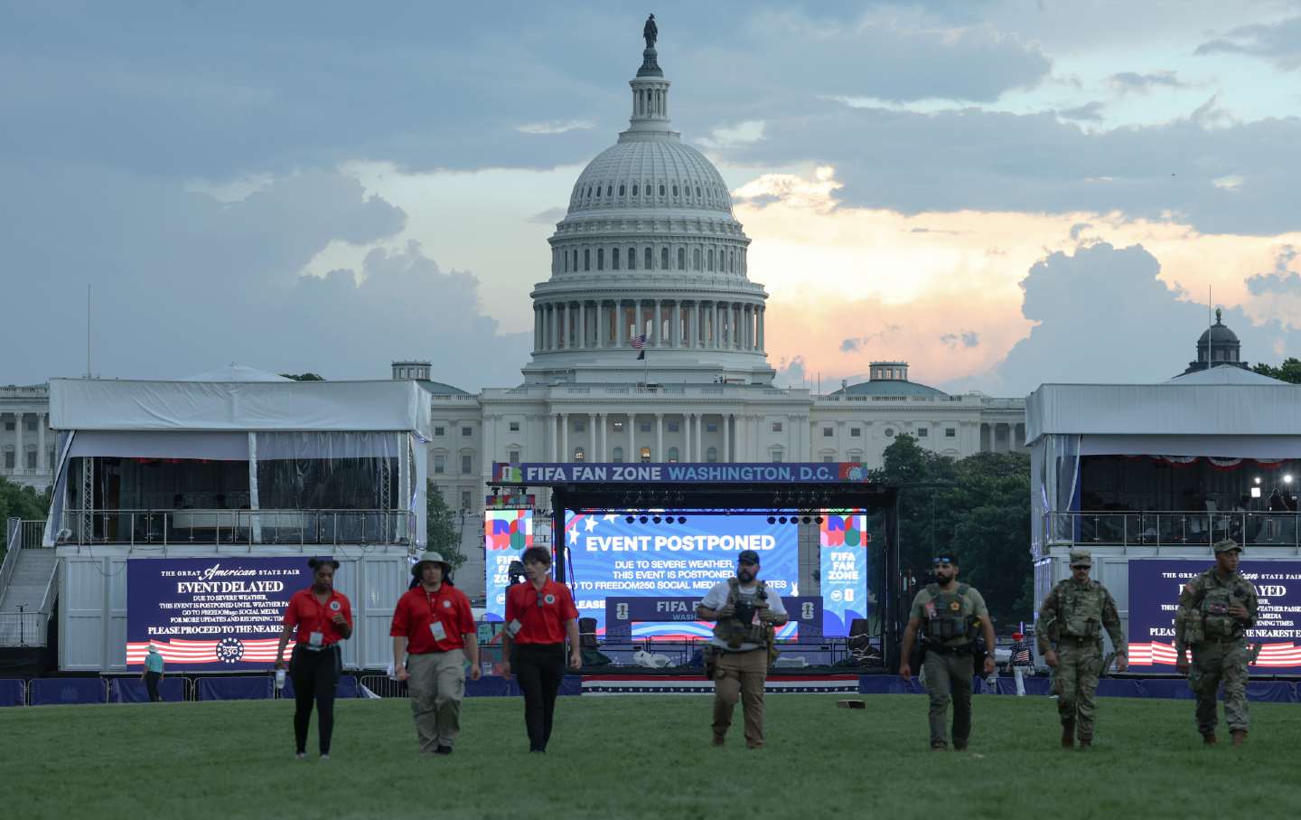National Guard members, law enforcement, and event staff try to clear out the grounds of the July 4 celebration on the National Mall ahead of severe weather.