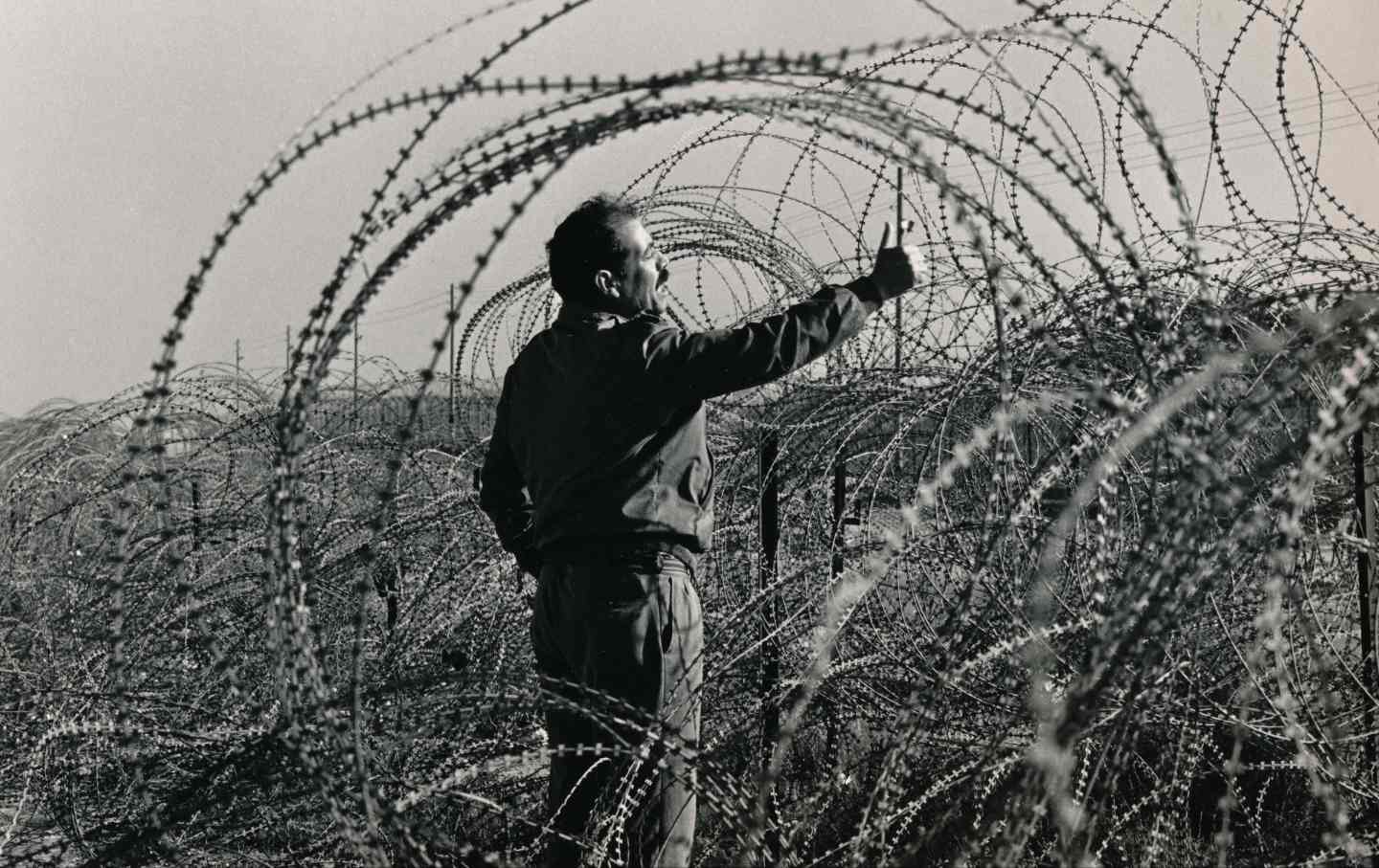 A Palestinian man at the "shouting fence" between Gaza and Egypt, 1984.