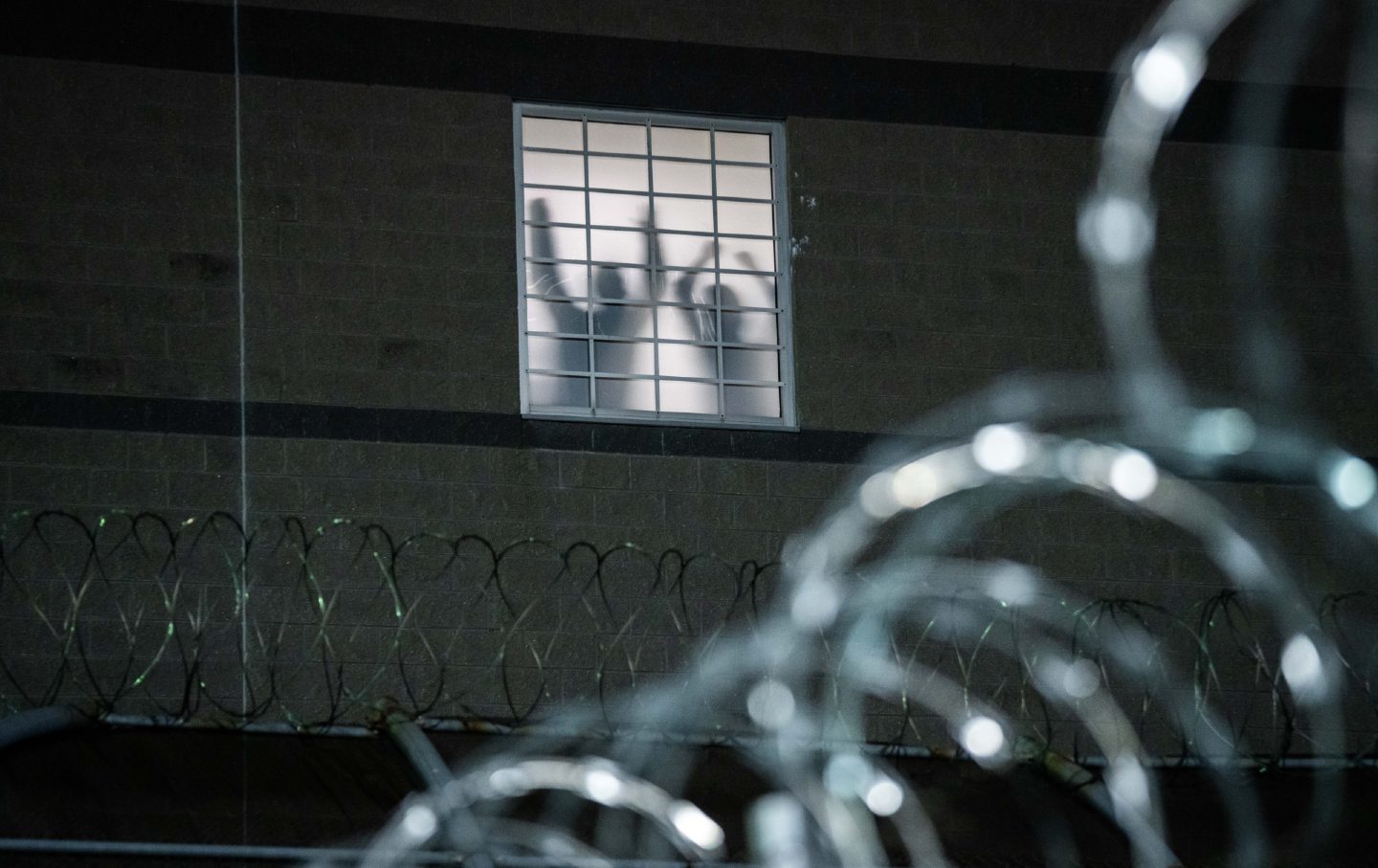 Detainees stand by a window inside the federal immigration center at Delaney Hall, where ICE is housing detained immigrants on May 26, 2026, in Newark, New Jersey.