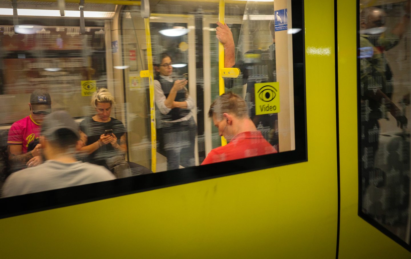 People look at their phones as they travel on a U-Bahn train at Alexanderplatz station in the Mitte area of Berlin, Germany, on August 26, 2024.