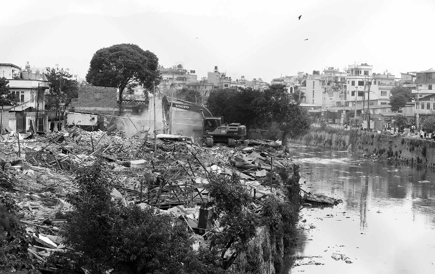 Bulldozers demolish shelters in Kathmandu, part of a nationwide drive to remove informal settlements built on public land.