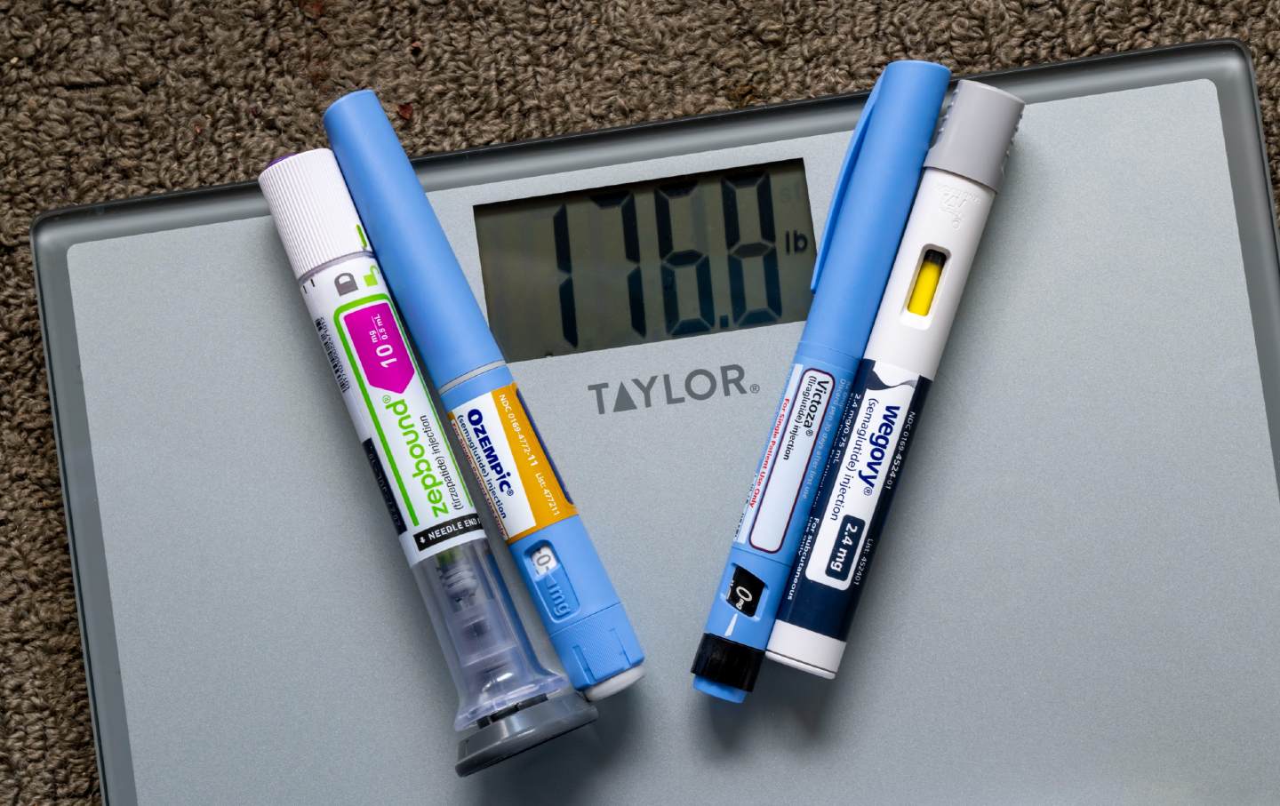Weight-loss injection pens on a scale.