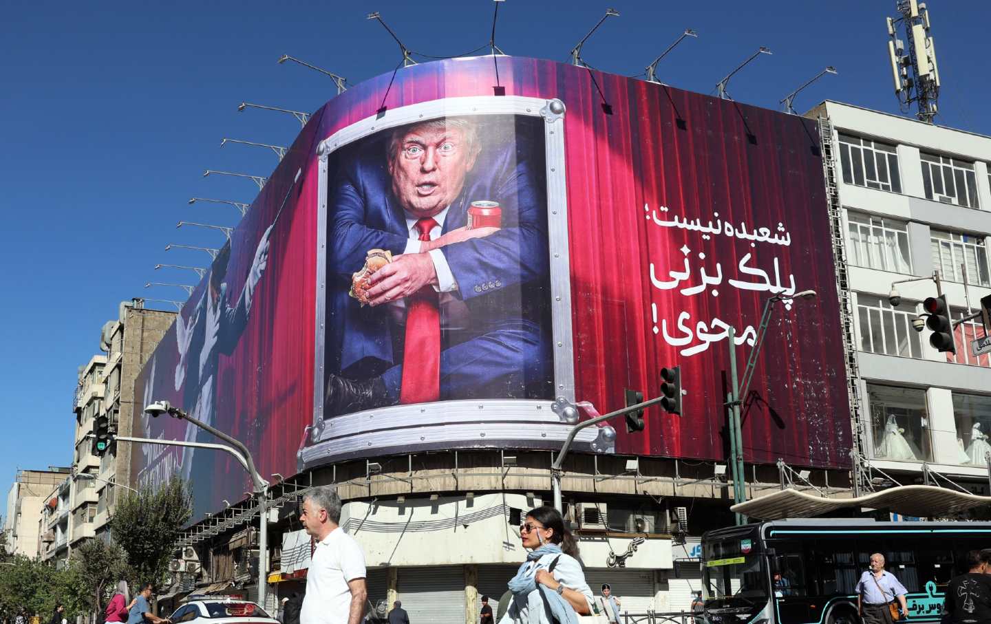 Iranians walk past an anti-Trump billboard along a street in Tehran on September 23, 2026.
