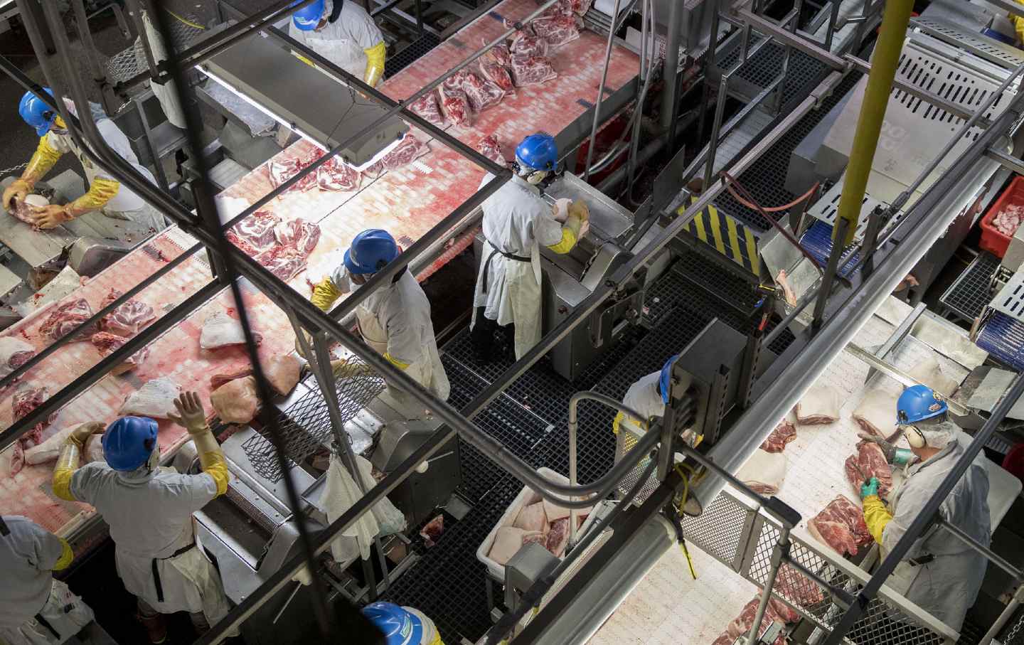 Employees butcher pork at a Smithfield Foods Inc. pork processing facility in Milan, Missouri, on April 12, 2017.