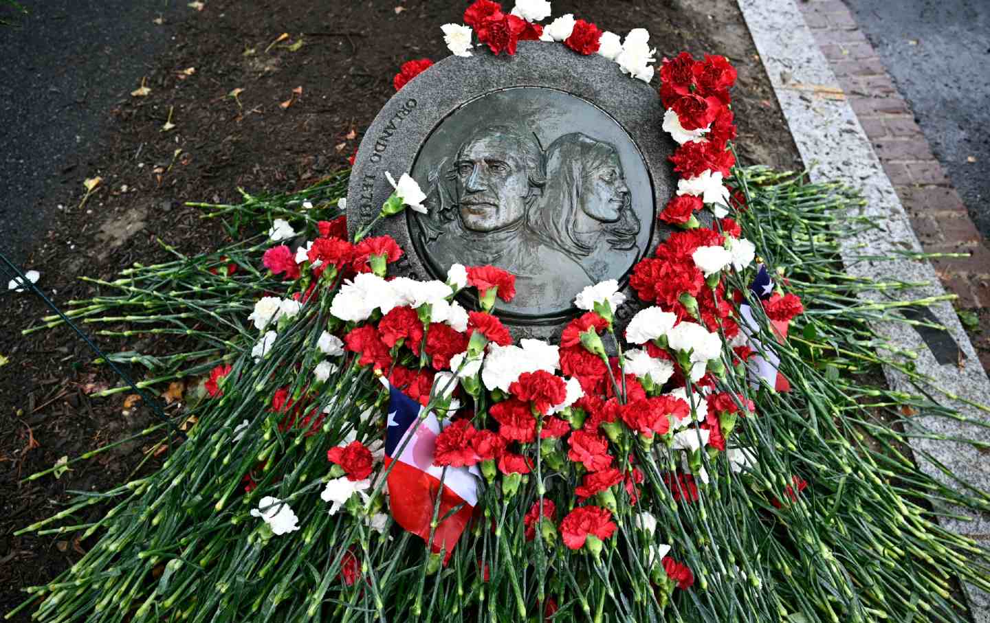 Flowers adorn the memorial plaque at the site where Orlandlo Letelier and Ronni Karpen Moffitt were killed in Washington, DC, by agents of Chilean dictator Augusto Pinochet.