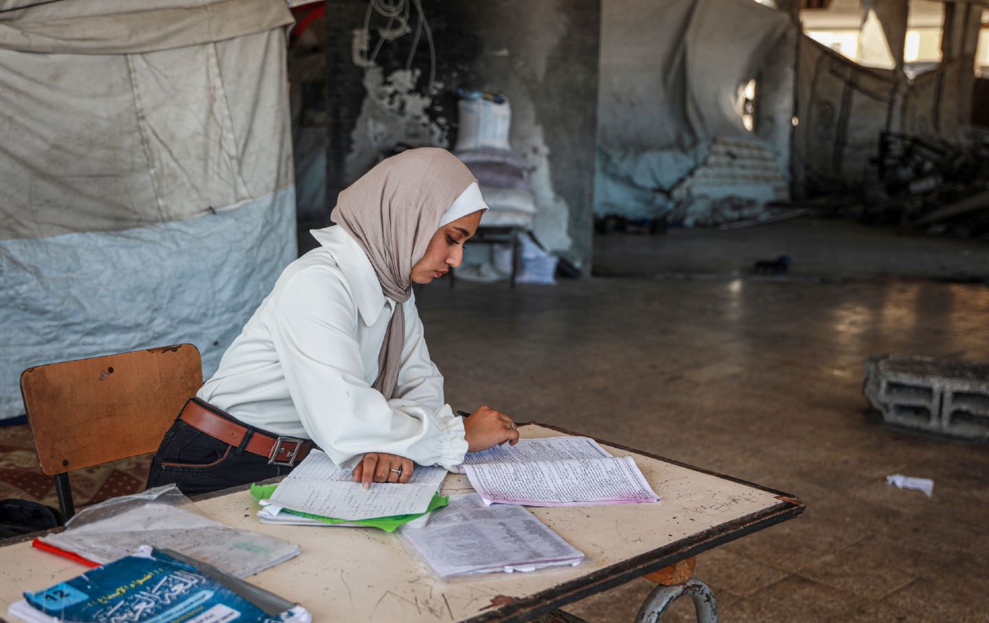 A student in Gaza's class of 2026 reviews for her final high school exam, the Tawjihi