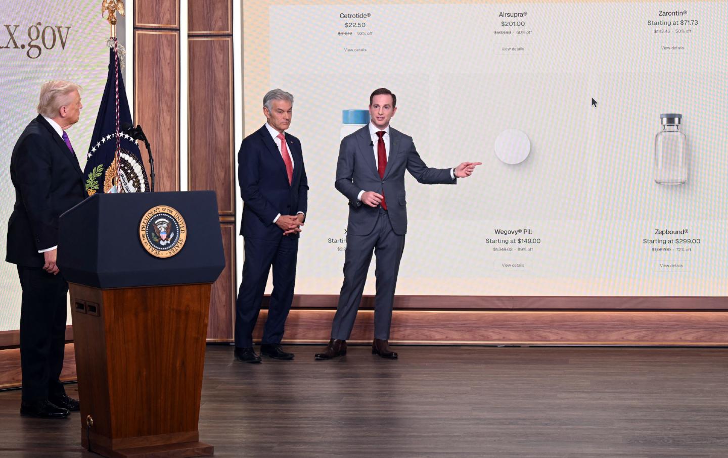 President Donald Trump and Mehmet Oz listen to Chief Design Officer of the National Design Studio Joe Gebbia describe the TrumpRx website, in Washington, DC, on February 5, 2026.