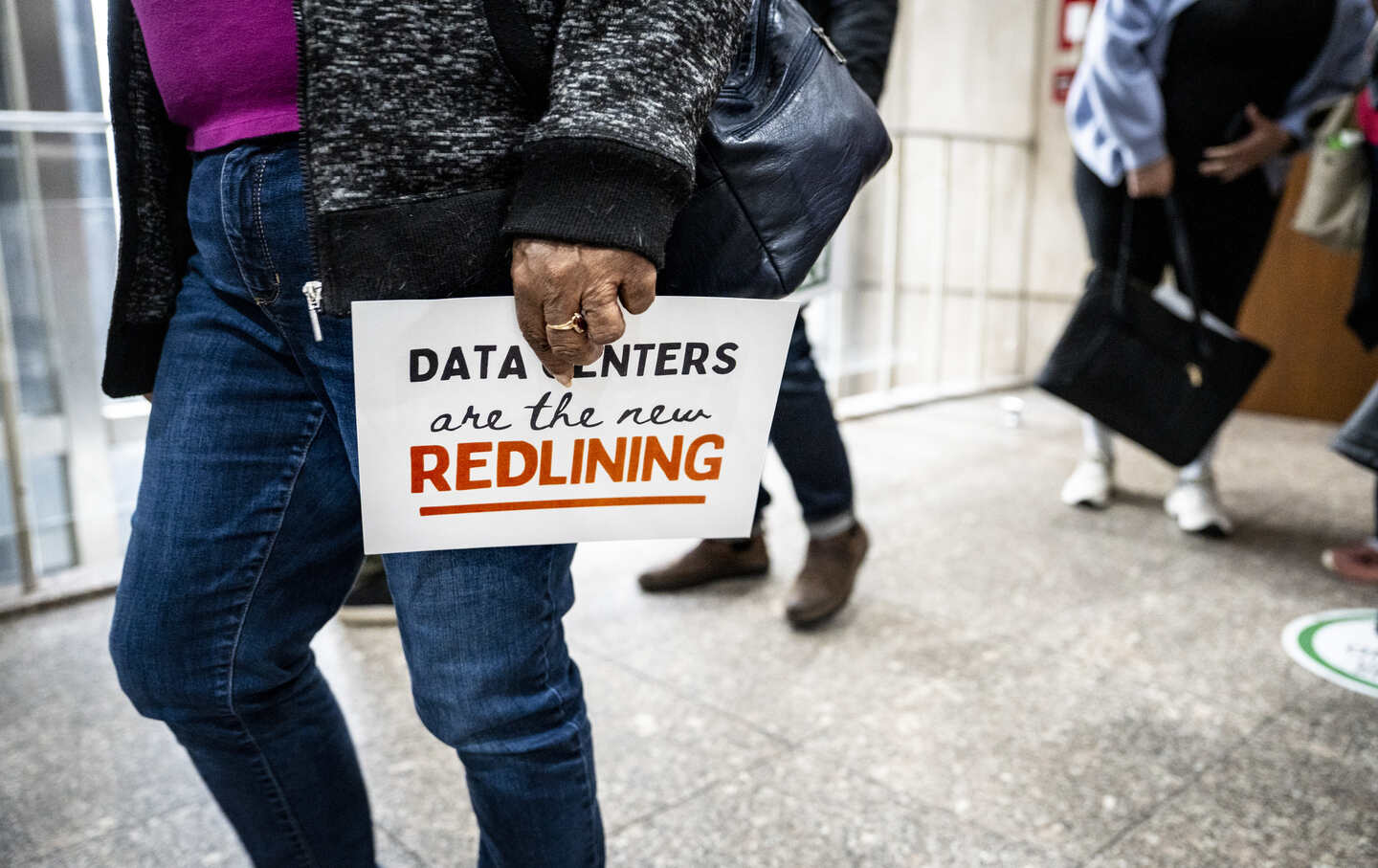 Audience members walk out of the Metropolitan Development Commission meeting on March 4, 2026, in Indianapolis, Indiana, after a one-month continuance was granted for the hearing of the Metroblocks data center in the Martindale Brightwood community.
