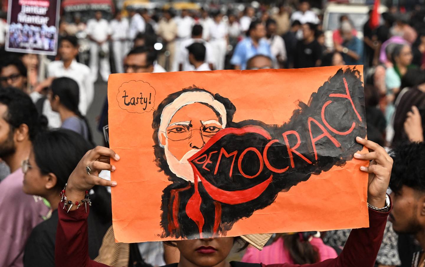 A student activist aligned with left-wing organizations holds a poster of Indian Prime Minister Narendra Modi amid the ongoing protest in solidarity with the youth-led Cockroach Janata Party demanding the resignation of the country's chief election commissioner, Gyanesh Kumar, over alleged voter roll irregularities linked to the “special intensive revision,” in Kolkata on October 11, 2026.