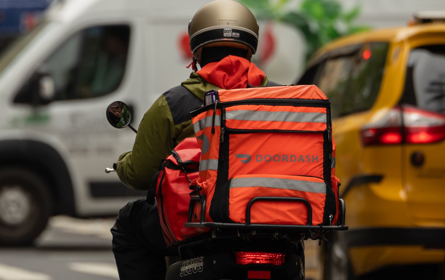 A delivery worker carries a DoorDash bag in New York City, on Tuesday, May 6, 2025.